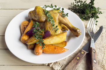 Roasted chicken with carrots and thyme.