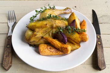 Roasted chicken with carrots and thyme.
