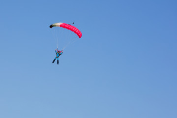  parachutist on background clear blue sky