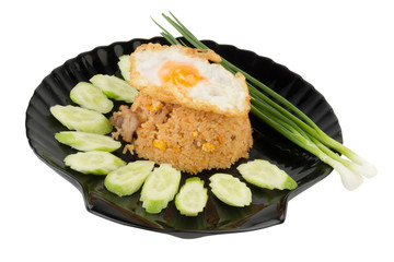 Fried rice pork with fried Egg on dish black. cucumber.Spring onion on isolated on white background