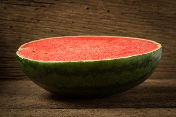 Half of ripe watermelon on old wood