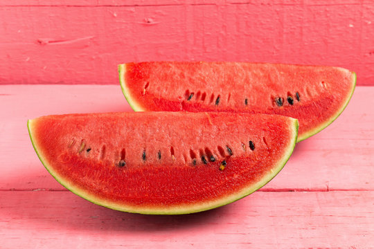 slice of ripe watermelon on wood pink