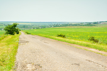The old asphalted road conducting to the village.