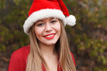 Young woman with Christmas hat in the forest