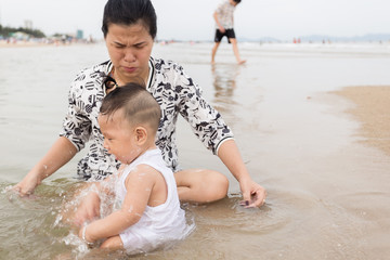 Mother and son playing on the beach