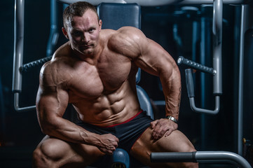 Fototapeta premium Handsome model young man posing in gym