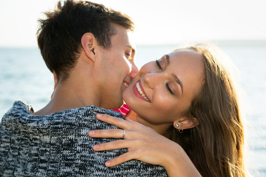 Young couple hugging on the beach