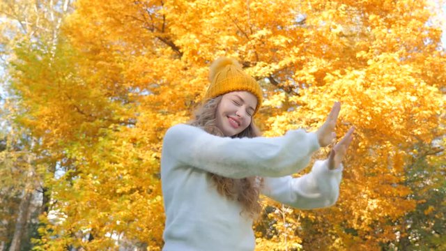 Autumn beautiful girl dancing in the forest. Woman spending holidays out of the city. People inspired by nature. Girl with yellow leaves. Autumn magic forest on the sunny day. Girl on the nature.