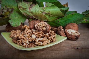walnuts (Juglans regia) on a light background with leaves from the stoma