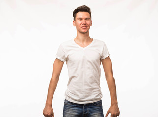 Fototapeta premium Young happy man portrait of a confident businessman showing by hands on a gray background. Ideal for banners, registration forms, presentation, landings, presenting concept.