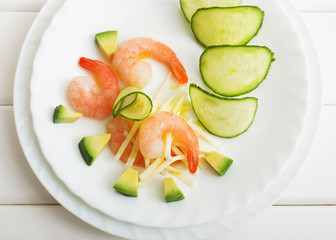 shrimp salad and avocado on a white wooden table