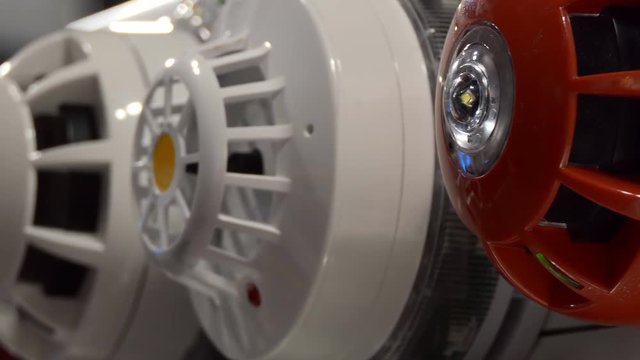 Panning shot of red and white fire security sounder group.Selective focus on the first on the right