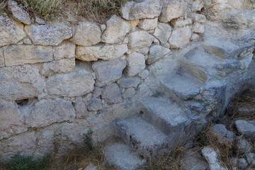 A narrow stone staircase leading to the fences of an ancient fortress. Horizontal.