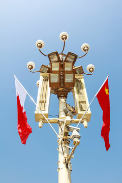 tall square lights and flags in front if Tiananmen