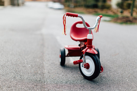 A tricycle parked in the middle of a street