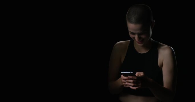 Gritty woman typing on smartphone