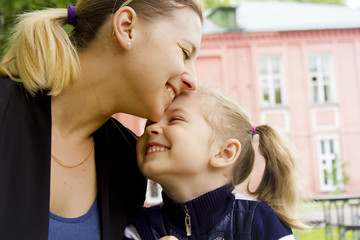 Fototapeta premium mother and daughter smiling on the street