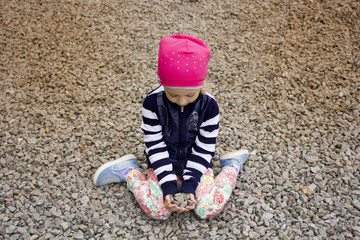 girl sitting on stones