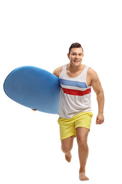 Young man with a surfboard running