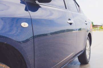 side view of blue car on road