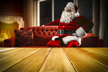 santa claus on sofa and wooden table place 