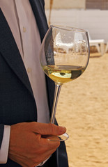 Hand with a glass of white wine
