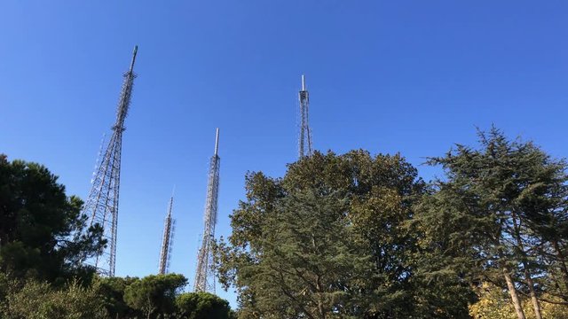 ''young man pulls the transmitter by using a camcorder top camera'' radio telecommunication tower 