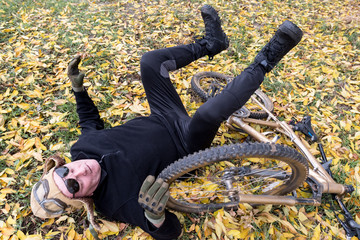 An elderly man fell off his bicycle for a walk.