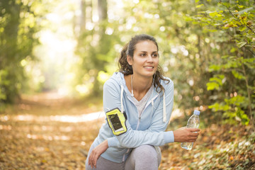 woman stretching out after running on forest in autumn
