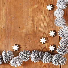 seasonal frame with cinnamon stars and pinecones
