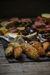 Fototapeta na wymiar a variety of snacks (antipasto) - cheese, olives, pate, jam, Madeleine and more
