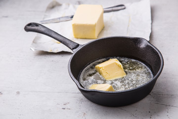 Butter. Pieces of butter in the hot pan top view