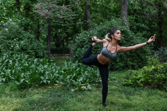 Beautiful woman meditating in park
