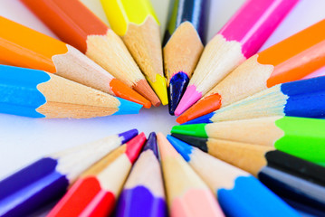 Closeup different colored pencils on white background.