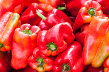 Background of red bell peppers (also known as sweet peppers or capsicum). Sineu market, Majorca, Spain