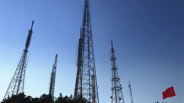 ''young man pulls the transmitter by using a camcorder top camera''  Turkish flag tower transmitter