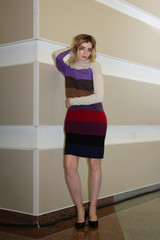 Fashion model demonstrating woolen clothes at backstage of fashion week