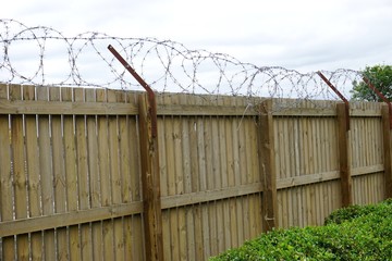 Barbed wire atop a barricade fence