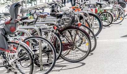 Naklejka na ściany i meble Bicycle rack in a pedestrian zone with parked bicycles