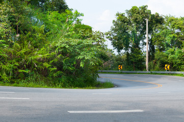 Countryside road with trees on both sides,Curve of the road to mountain