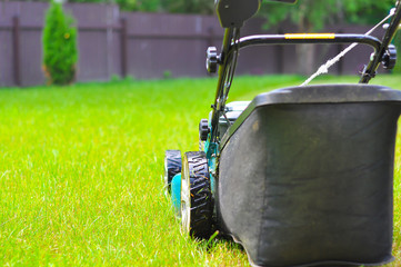 Fototapeta premium the lawn-mower on a bright juicy grass