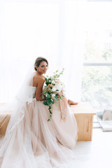 beautiful bride in a luxurious dress in eco-style