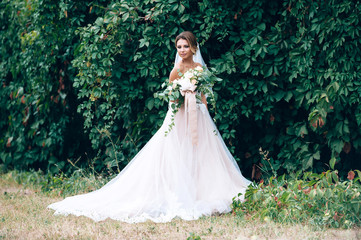 Fototapeta premium beautiful bride in a luxurious dress in eco-style