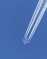 Commercial airplane flying on blue sky
