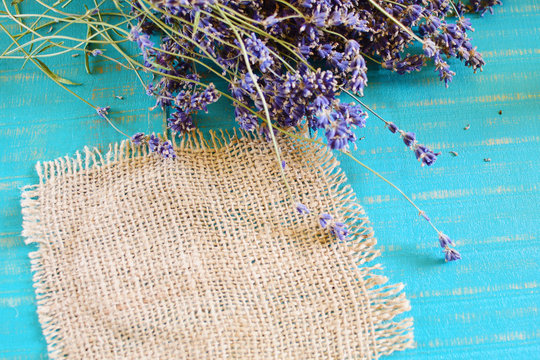 Fototapeta lavender and burlap cloth on wooden background