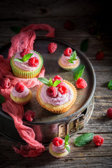 Tasty raspberry cupcake made of cream and fruits