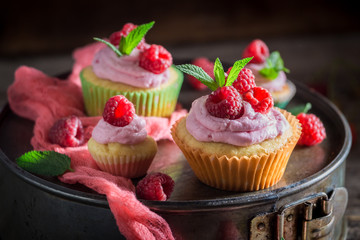 Fresh raspberry muffin with berries and pink cream