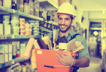 Master holding basket with tools in paint shop