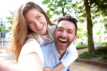 Obraz premium Selfie portrait of happy couple on date outside in park