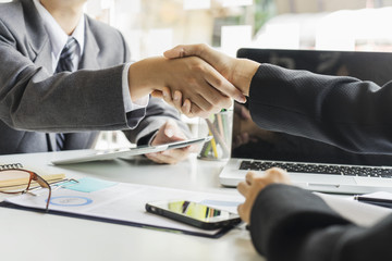 Couple of Business people talking and checking hand action with happiness in the modern Office	